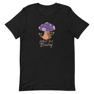 Black heather short-sleeve t-shirt featuring a purple toadstool mushroom with four smaller mushrooms budding from the stipe. Text underneath reads "What We Bury."