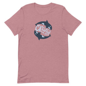 Heather orchid (mauve/pink) short-sleeve t-shirt featuring two orca whales swimming in a circle. Text between them reads "Orcinia, est. 1979."