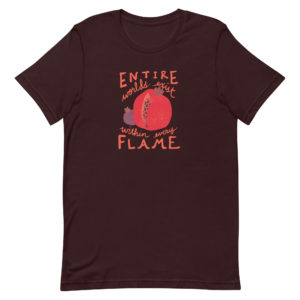 Oxblood black short-sleeve t-shirt featuring a large red pomegranate and smaller purple pomegranate surrounded by the inscription, "Entire worlds exist within every flame."