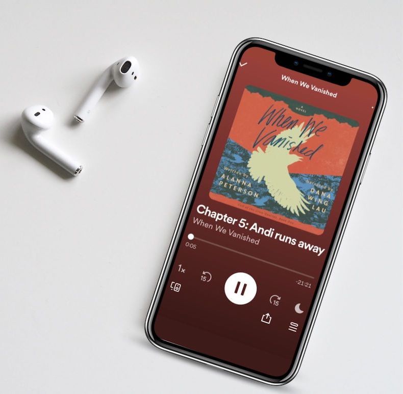 A phone playing Chapter 5 of the When We Vanished audiobook with nearby airpods
